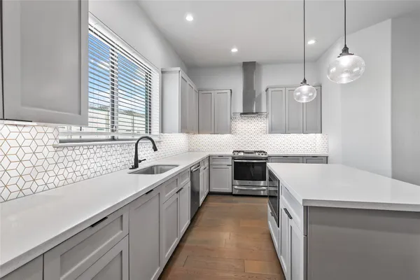 a kitchen with a sink stove and cabinets