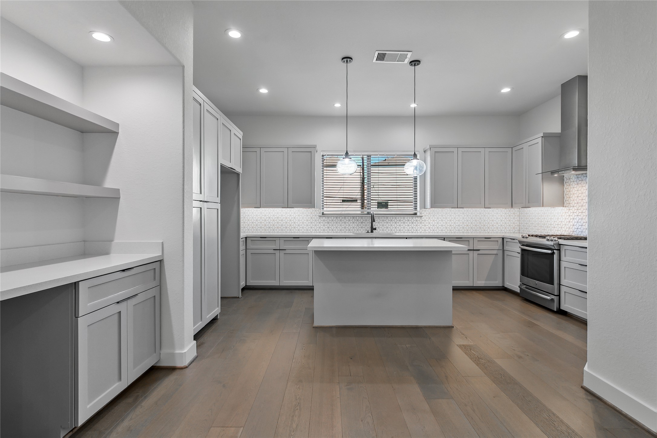 4231 Allen Street Houston, TX 77007 - Photo 3 of 31 a kitchen with kitchen island a sink stainless steel appliances and cabinets