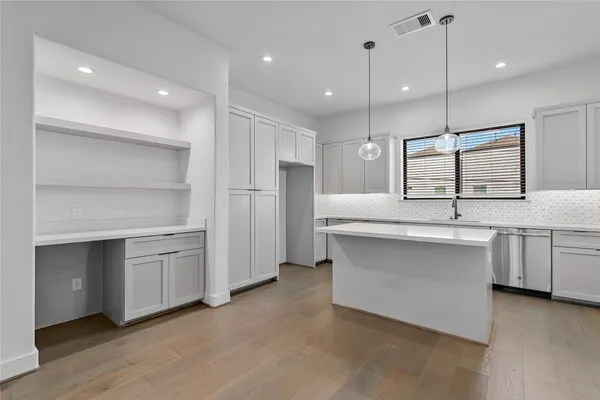 a large kitchen with a lot of counter space and a sink