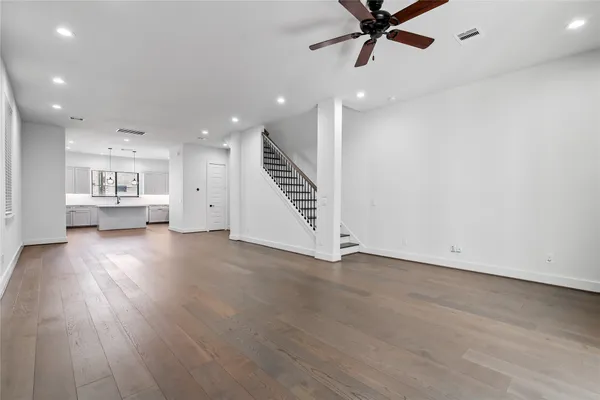 a view of kitchen and hall with wooden floor