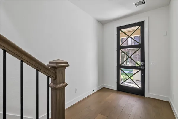 an empty room with a window and mirror