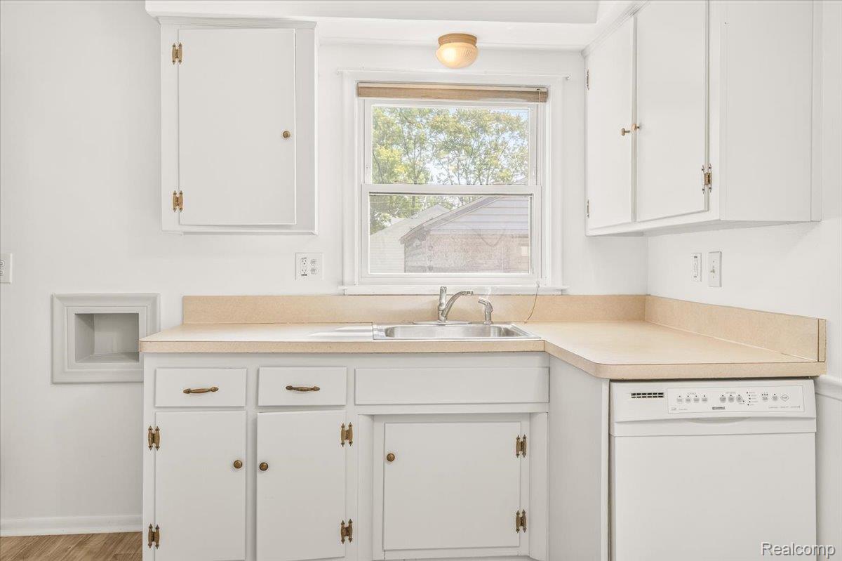 11802 Columbia Street Redford, MI 48239 - Photo 10 of 39 Kitchen featuring new Vinyl Flooring and freshly painted cabinetry.