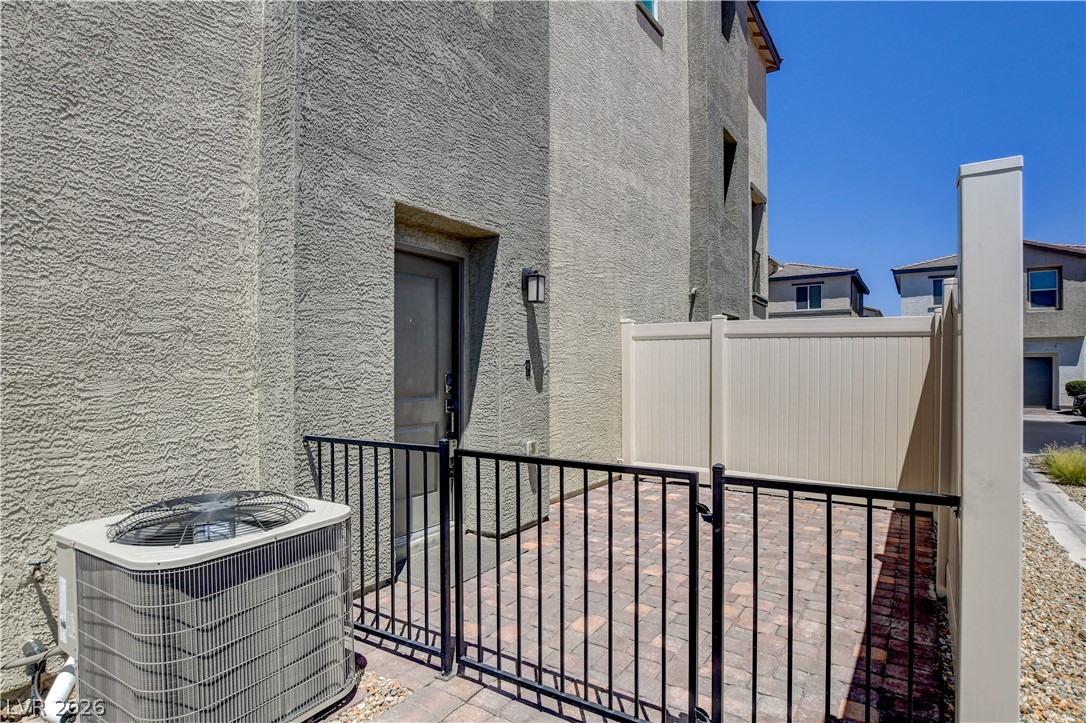 6924 Spicy Merlot Street North Las Vegas, NV 89086 - Photo 4 of 83 A private outdoor space with durable paver flooring and a robust privacy fence, ideal for relaxation.