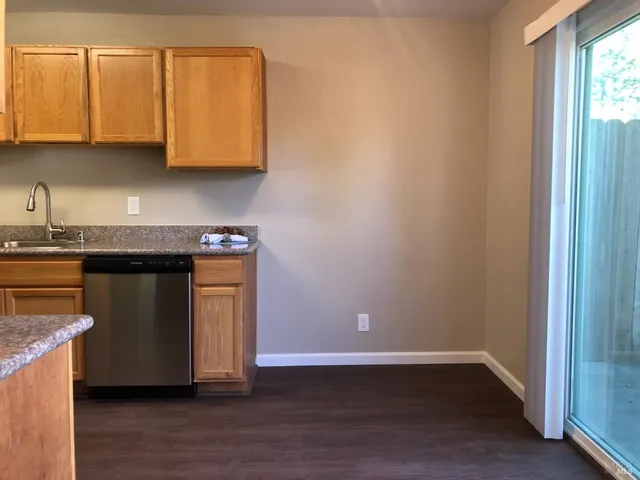 a view of a kitchen with sink and cabinets