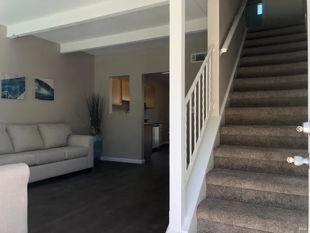 a living room with furniture and a entryway