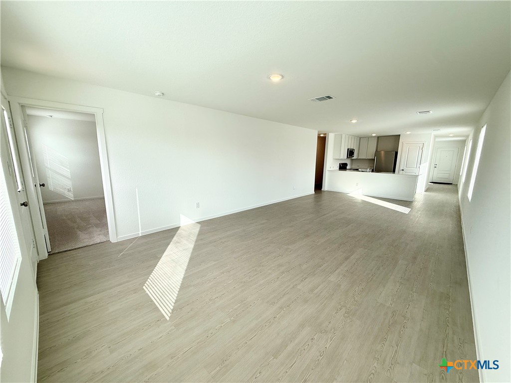 311 Moscato Road New Braunfels, TX 78130 - Photo 11 of 38 a view of a livingroom with wooden floor