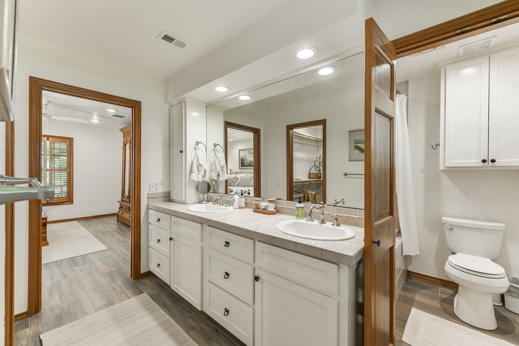 0 County Road Evant, TX 76525 - Photo 36 of 41 a spacious bathroom with a toilet sink and mirror