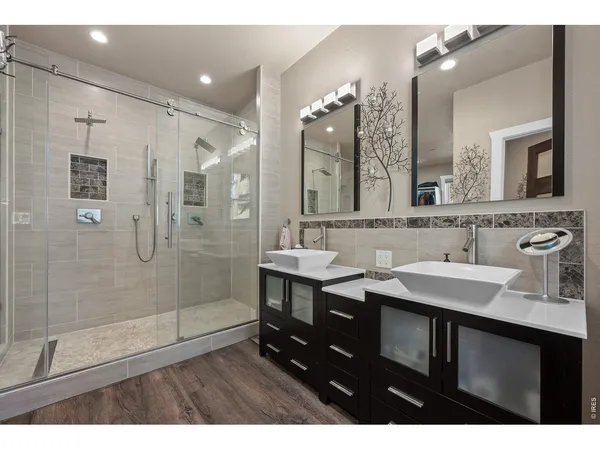 a bathroom with a sink double vanity and a mirror