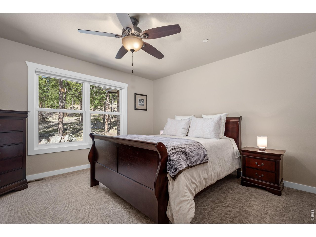 820 Peakview Road Boulder, CO 80302 - Photo 27 of 50 a spacious bedroom with a bed and a chandelier