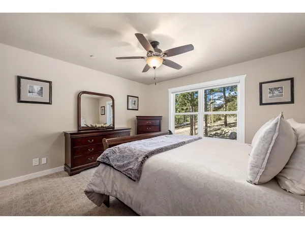 a bedroom with a large bed and a chandelier