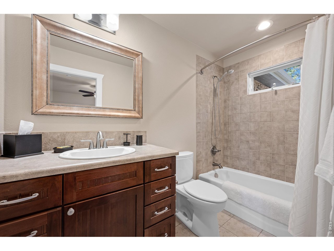 820 Peakview Road Boulder, CO 80302 - Photo 31 of 50 a bathroom with a granite countertop sink toilet a mirror and shower
