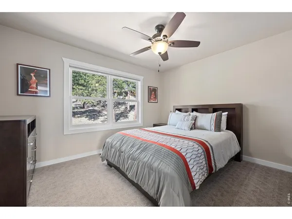 a bedroom with a large bed and a window