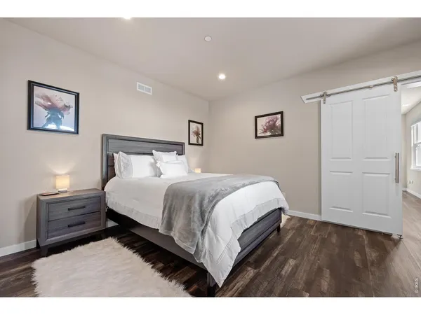 a bedroom with a bed and a desk