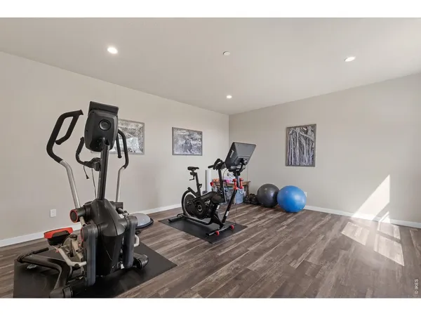 a living room with furniture pool table and window