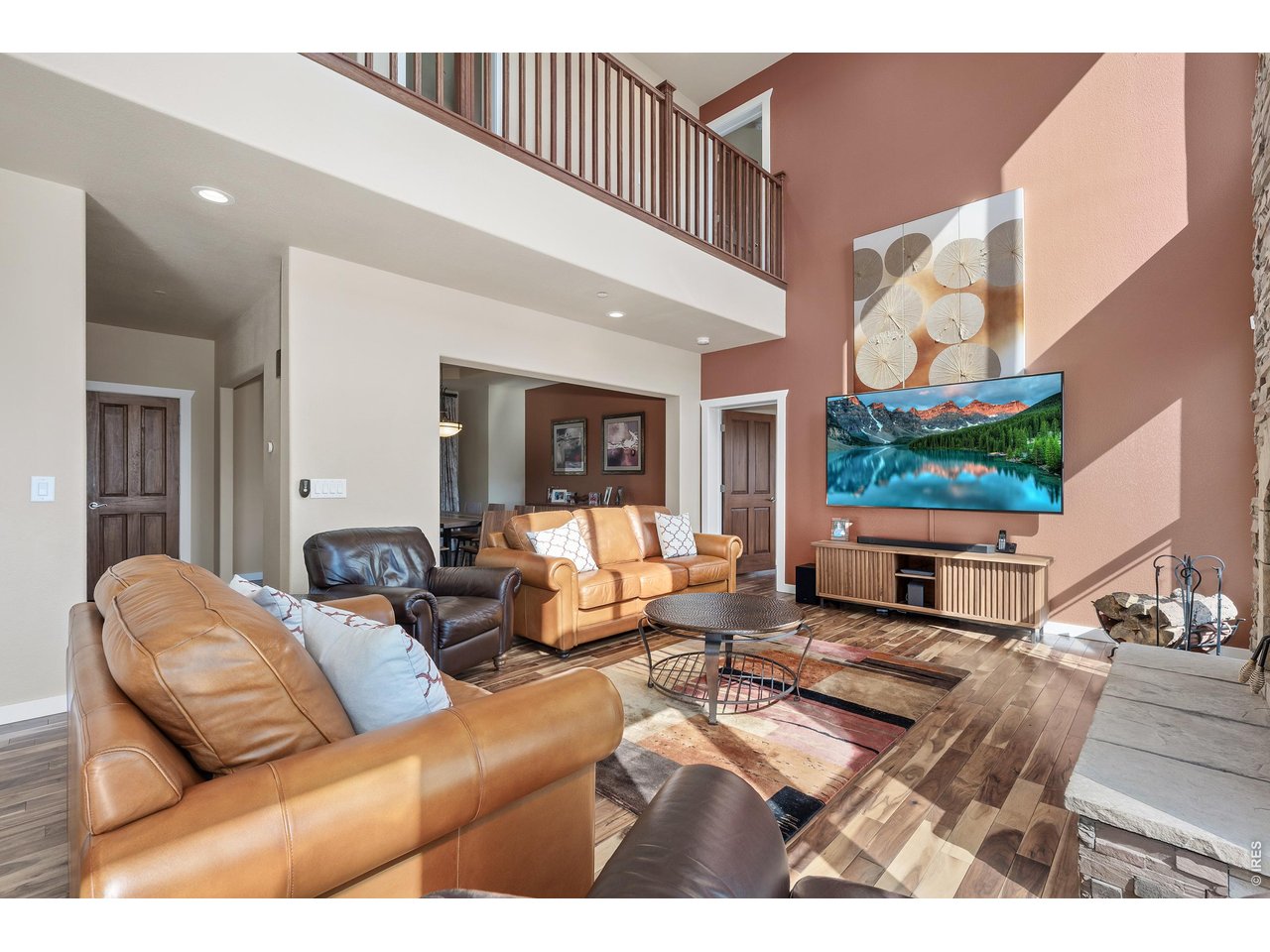 820 Peakview Road Boulder, CO 80302 - Photo 9 of 50 a living room with furniture a flat screen tv and a floor to ceiling window
