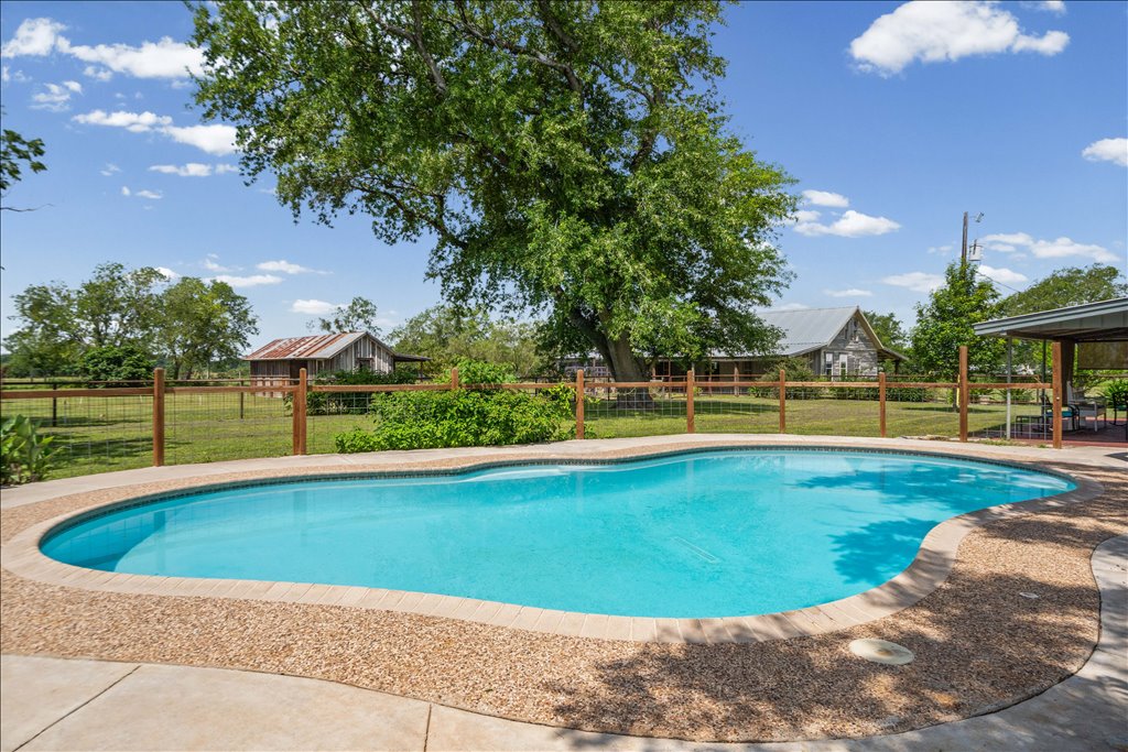 2421 Post Oak Road Webberville, TX 78653 - Photo 26 of 36 You will love this gorgeous, sparkling in-ground pool! It is completely fenced off from the rest of the pasture, and it offers the most relaxing, unobstructed views of the surrounding countryside while you swim.