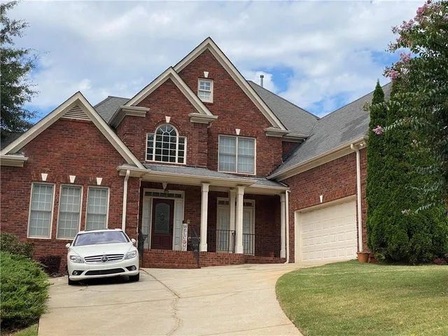 a car parked in front of white house