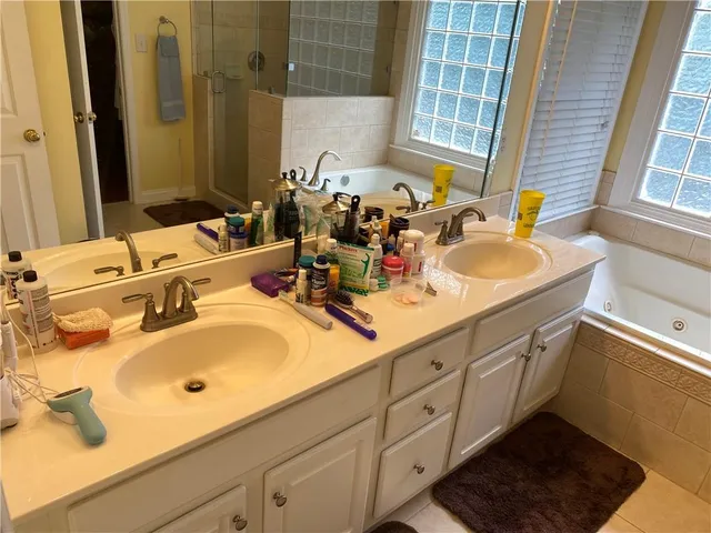 a bathroom with a shower and a sink