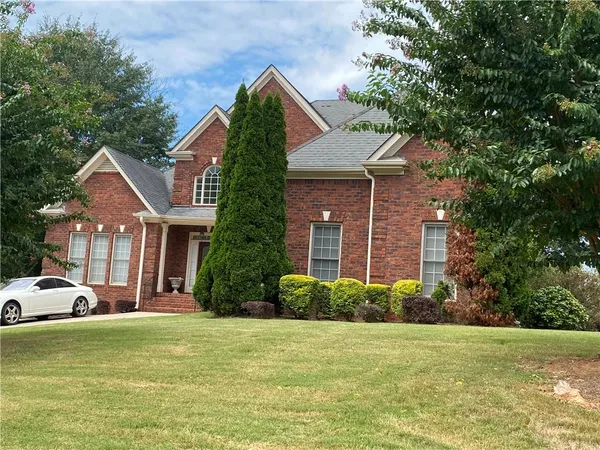 a front view of a house with a garden