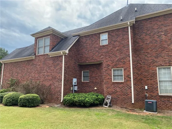 a brick house with a yard