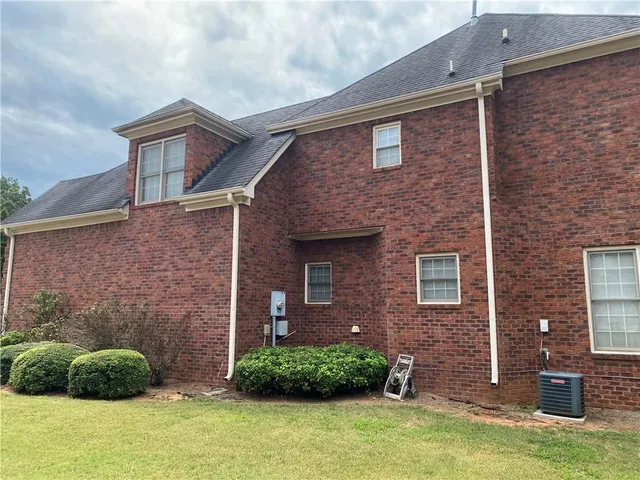 a brick house with a yard