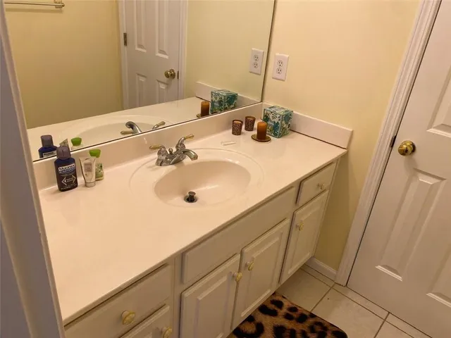 a bathroom with a sink and cabinets