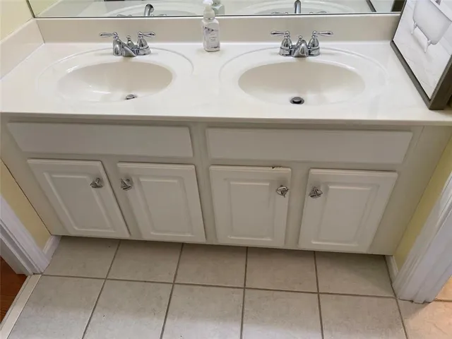 a bedroom with a bed and a chandelier fan