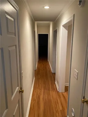 a room with gym equipment and wooden floor