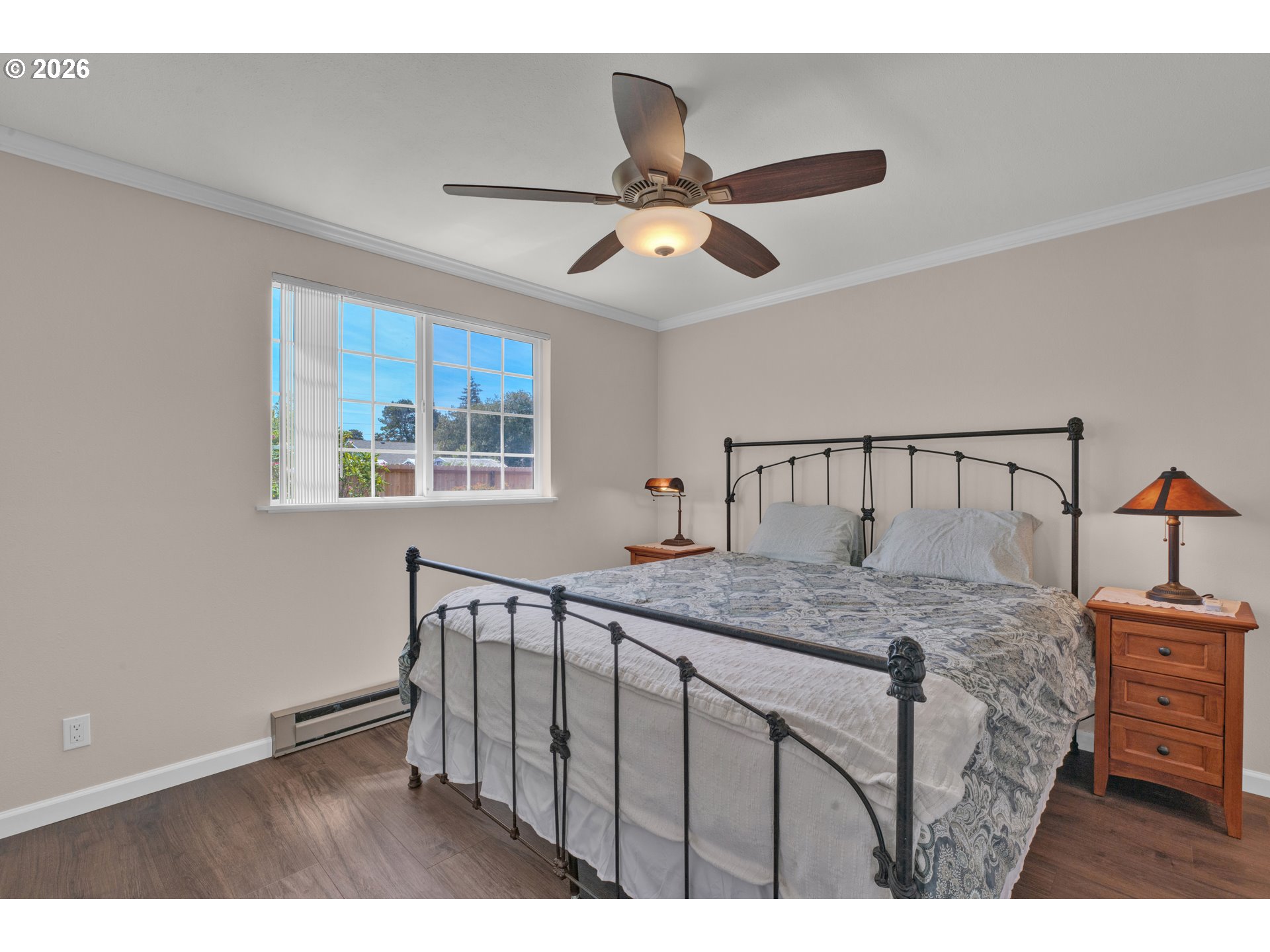 1142 9th Street Florence, OR 97439 - Photo 18 of 41 a bedroom with a bed and a chandelier