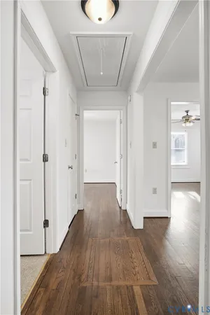 a view of a hallway with wooden floor