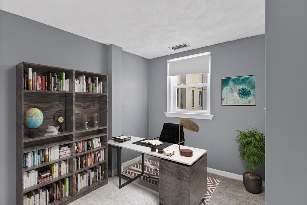88 Gordon Street, Unit 204 Boston, MA 02135 - Photo 7 of 12 a workspace with furniture and a book shelf