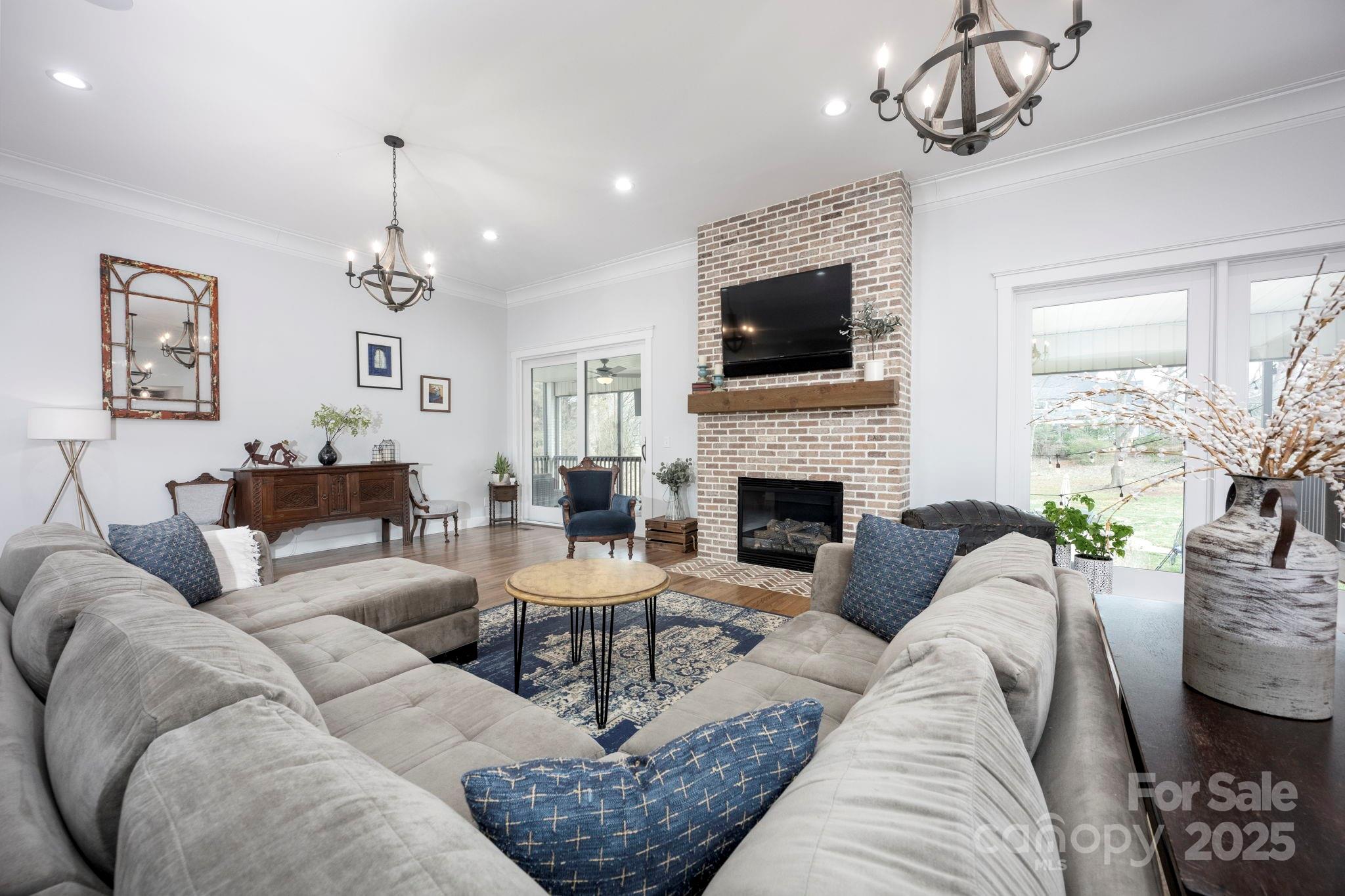 241 Spring Run Road Mooresville, NC 28117 - Photo 12 of 45 a living room with furniture a fireplace and a chandelier