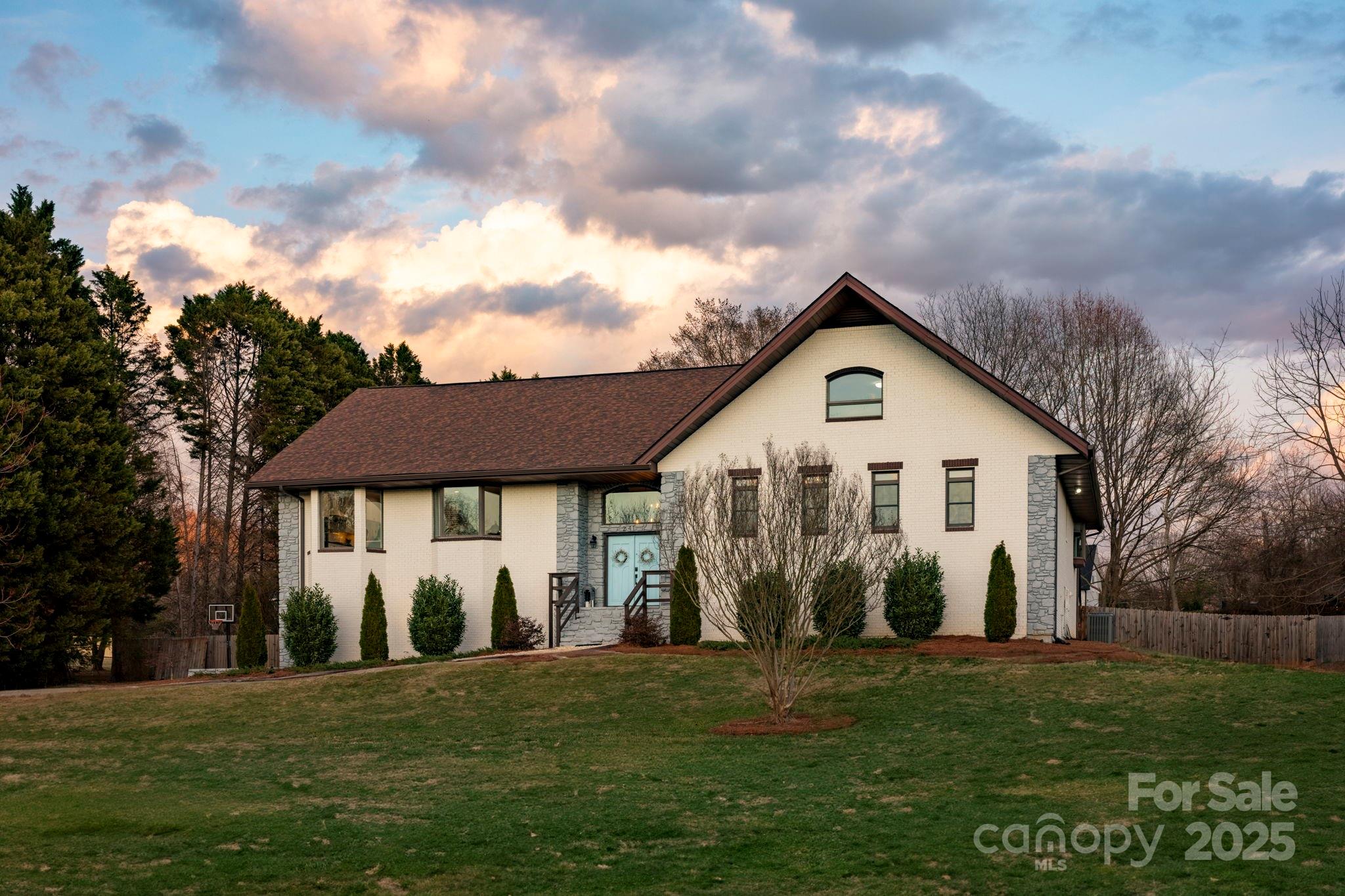 241 Spring Run Road Mooresville, NC 28117 - Photo 42 of 45 a view of a yard in front of a house with plants and large tree