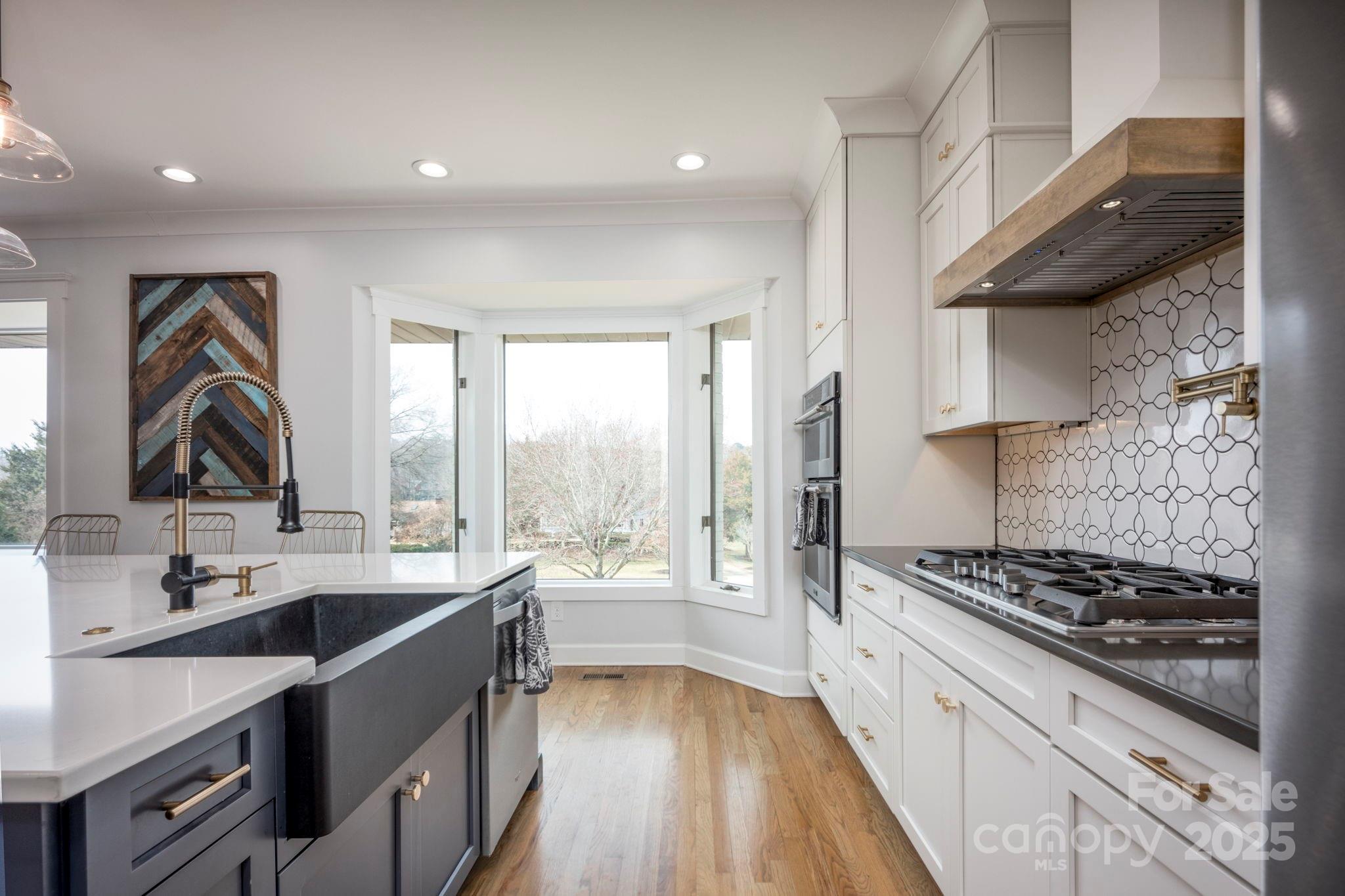 241 Spring Run Road Mooresville, NC 28117 - Photo 5 of 45 a kitchen with a sink a stove and a wooden floor