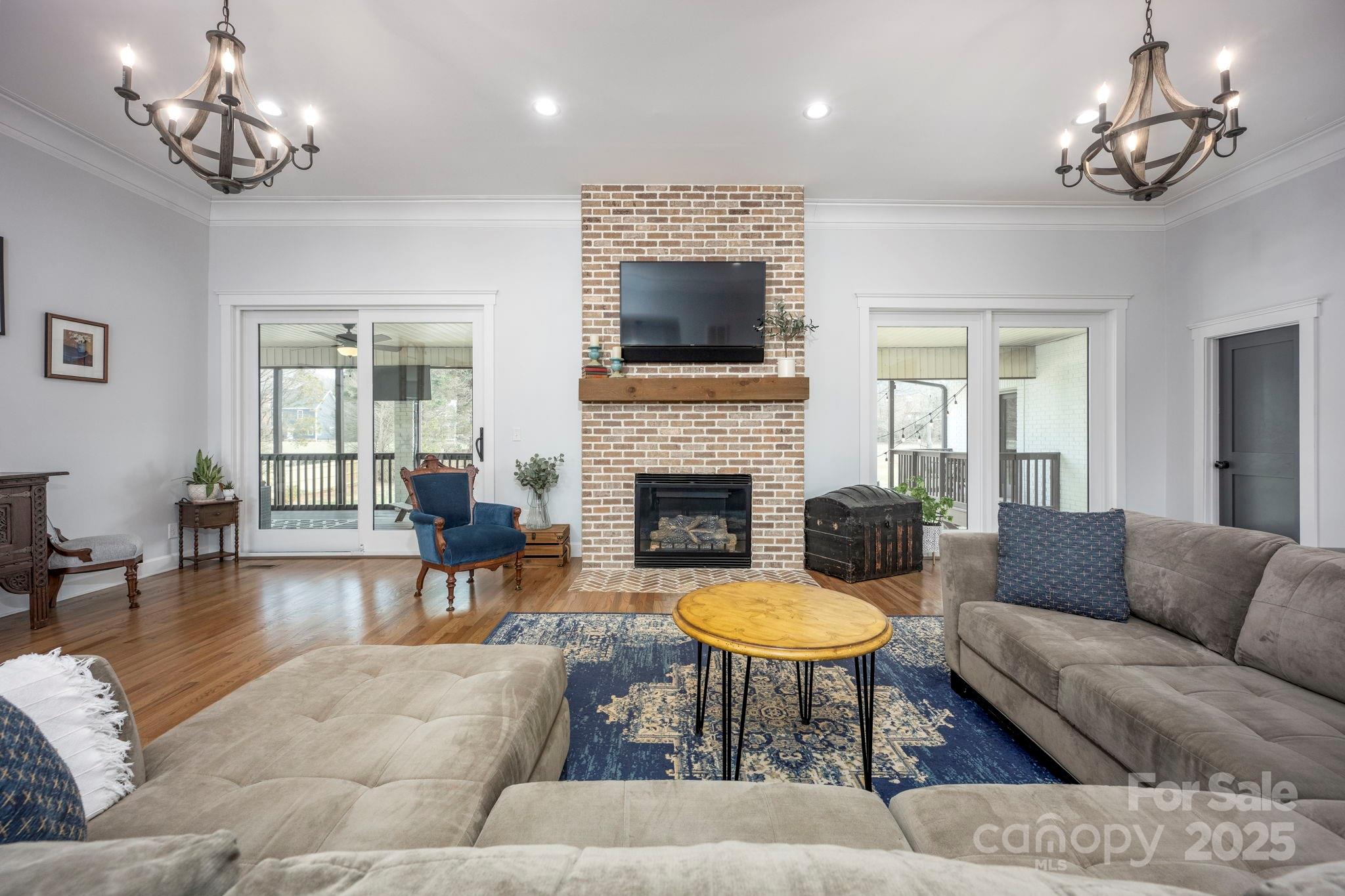 241 Spring Run Road Mooresville, NC 28117 - Photo 10 of 45 a living room with furniture a flat screen tv and a fireplace