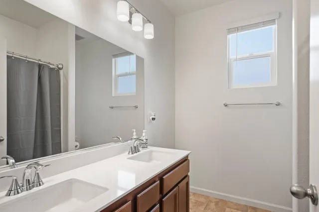a bathroom with a sink vanity and a mirror