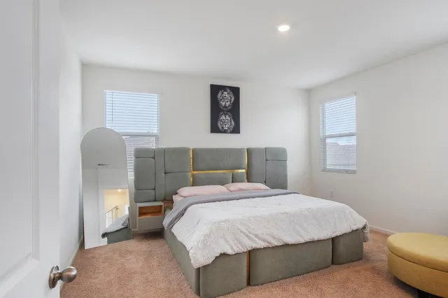 a bedroom with a bed and a chair