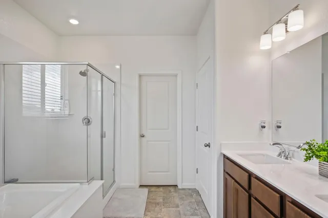 a bathroom with a granite countertop sink and shower
