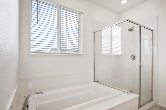 a bathroom with a tub and a shower