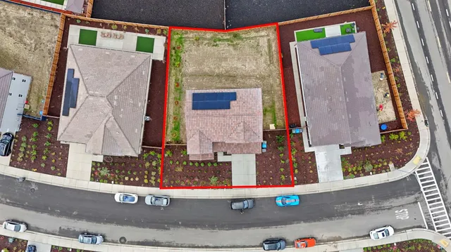 an aerial view of a residential apartment building with a street