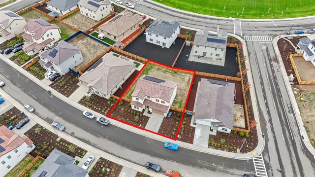 an aerial view of a residential houses with outdoor space