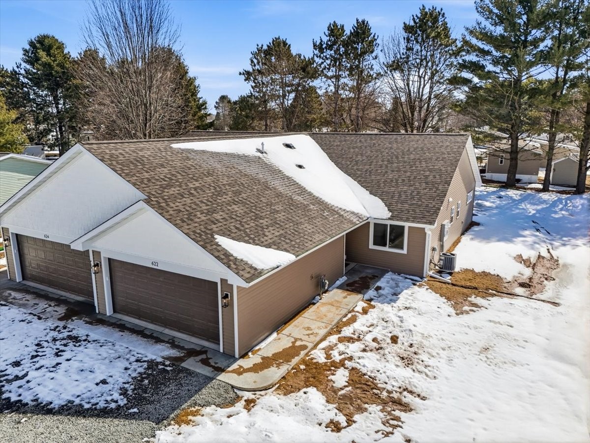 622 Sundance Street Amery, WI 54001 - Photo 2 of 24 Two car garage with sidewalk to front door.