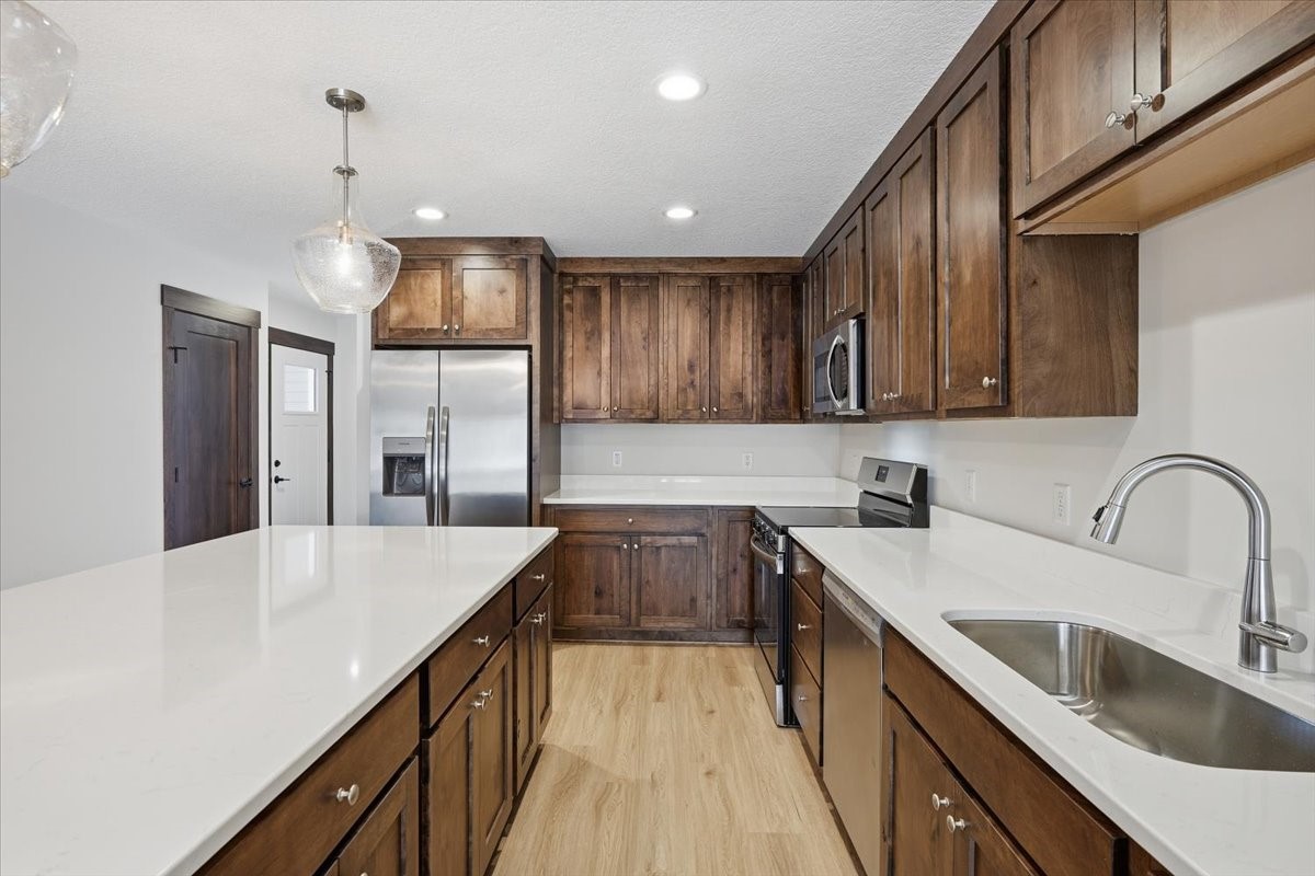 622 Sundance Street Amery, WI 54001 - Photo 5 of 24 Gorgeous dark wood with white countertops and backsplash.