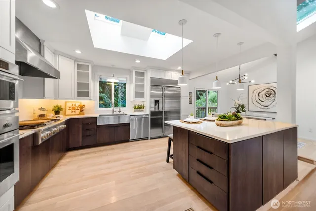 a kitchen with a stove sink and cabinets