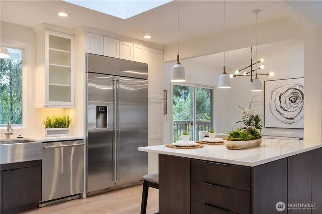 a kitchen with kitchen island a counter appliances and cabinets
