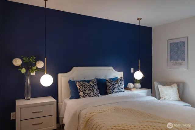 a bedroom with a bed and lamps