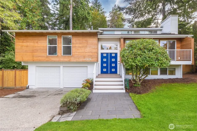 a front view of a house with a yard and a garage