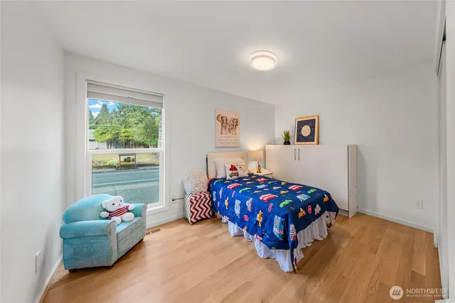 a bedroom with bed and a window