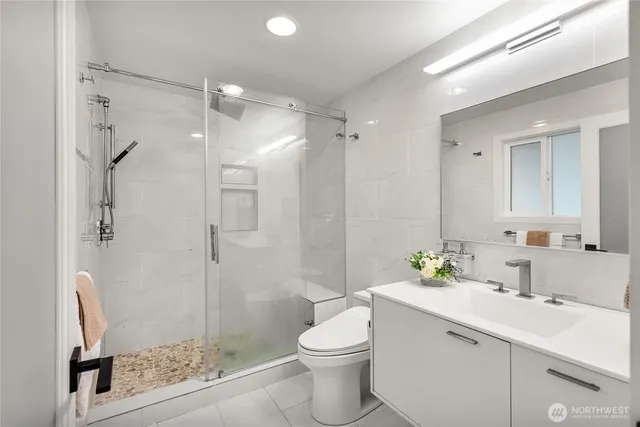 a bathroom with a sink toilet and shower