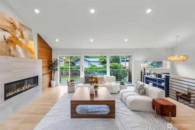 a living room with furniture large window and a fireplace
